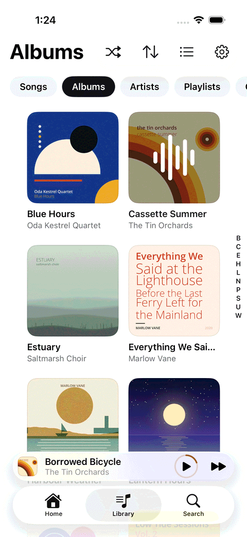 Shuttle Music on iPhone: the Albums tab, a grid of album covers